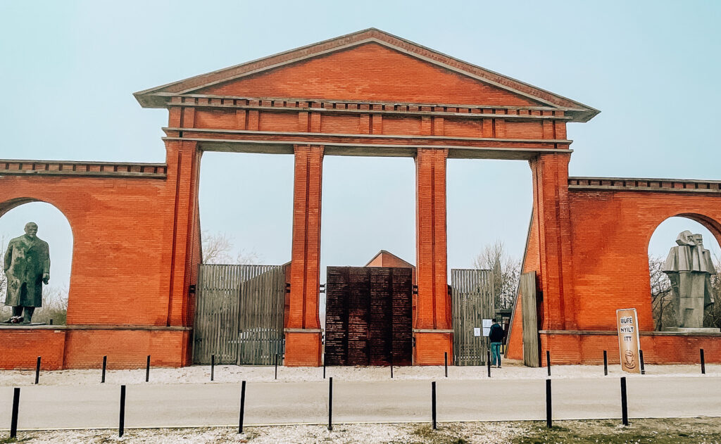 Il portale d'ingresso al Memento Park. Sono presenti le statue di Lenin sulla sinistra e di Marx sulla destra.